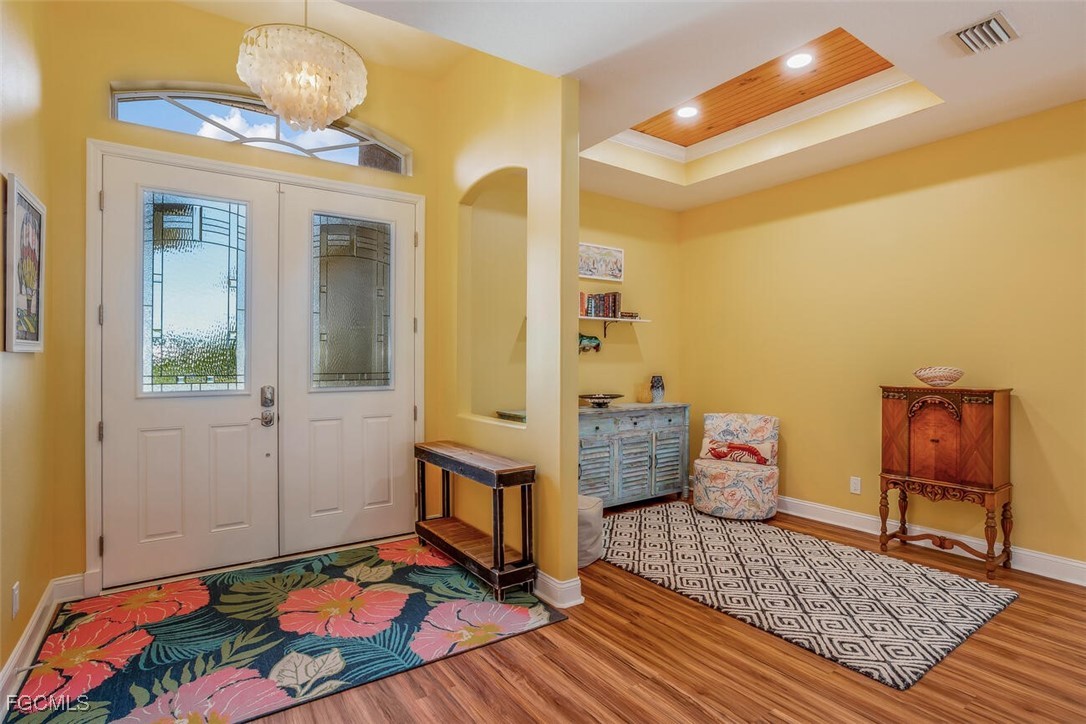 139 Crevalle Road Rotonda West, FL 33947 - Photo 6 of 24 a bedroom with a bed and wooden floor