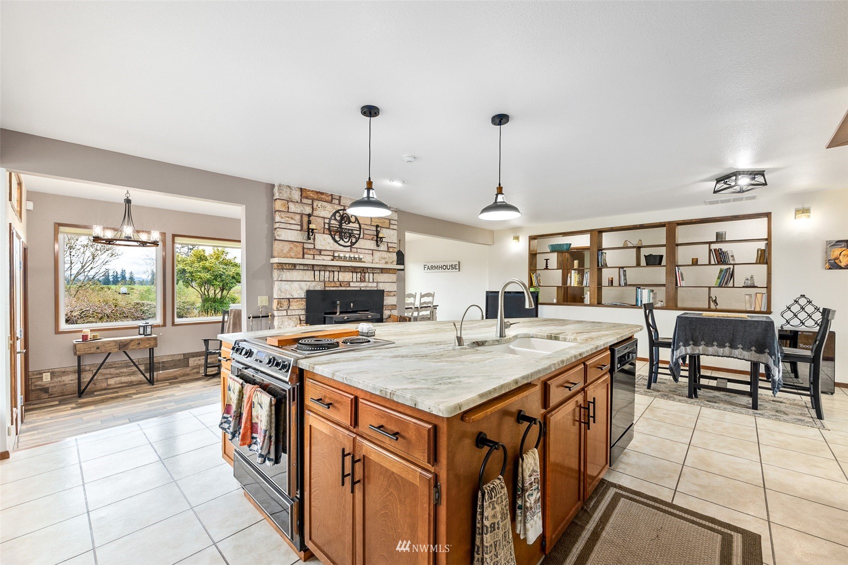 1096 North Military Road Winlock, WA 98596 - Photo 8 of 40 a open kitchen with stainless steel appliances granite countertop a stove and chairs