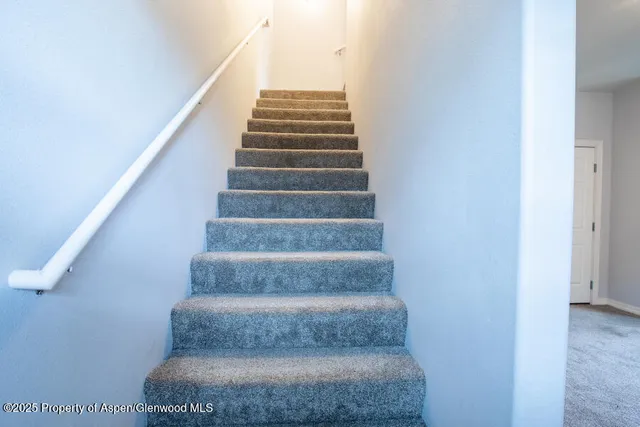 a view of staircase with white walls