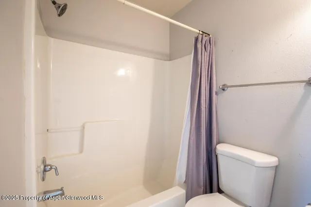 a white toilet sitting next to a bathroom sink