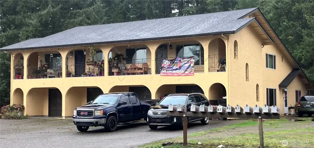 a couple of cars parked in front of a house
