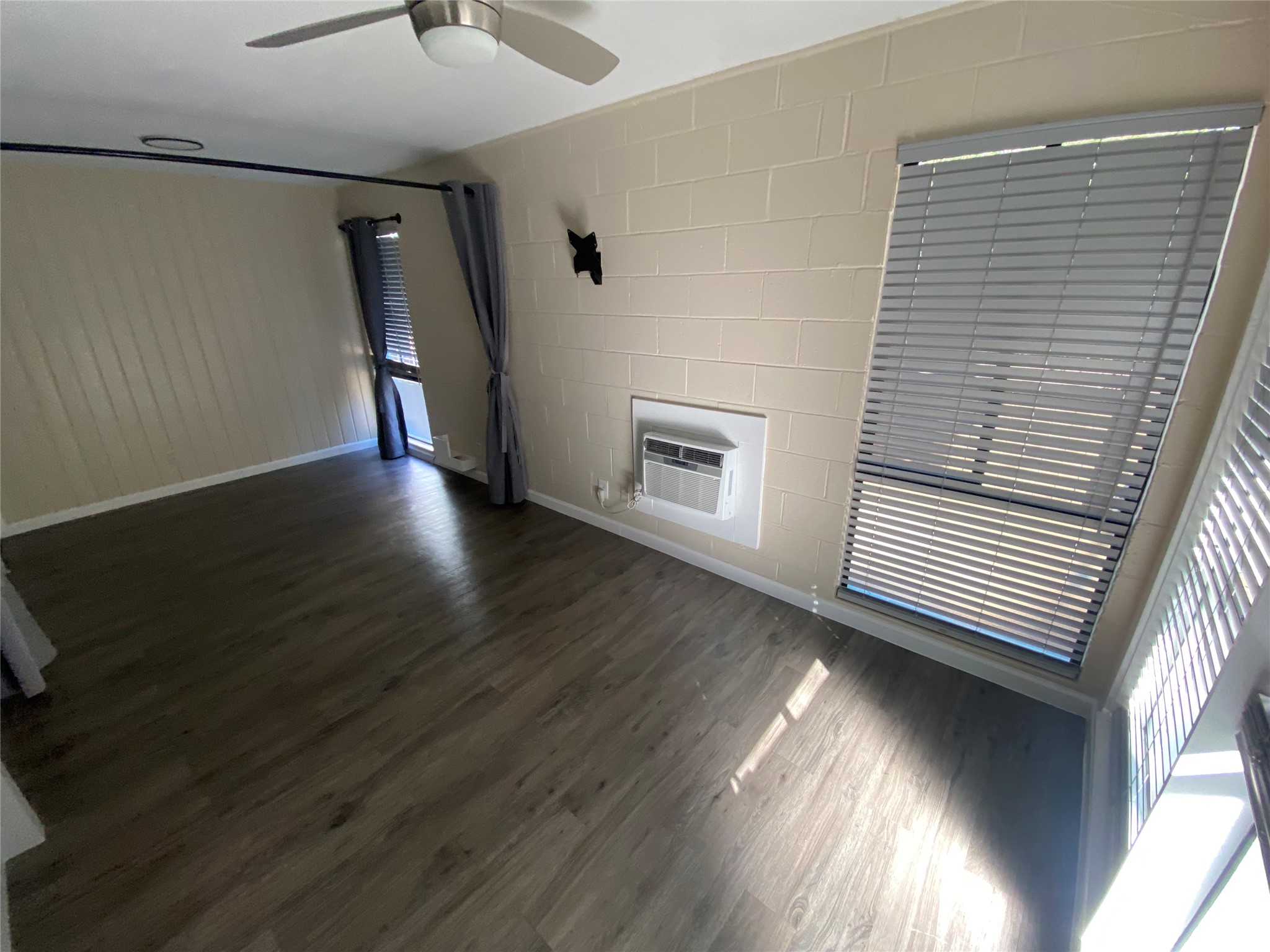 3010 Fruth Street, Unit B Austin, TX 78705 - Photo 21 of 32 Well-lit living area featuring rich wood-look flooring and ample natural light.