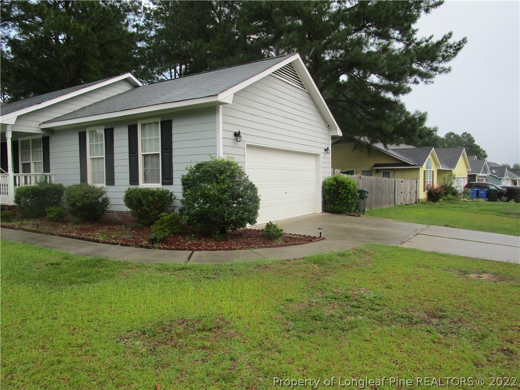 800 Turkey Ridge Drive Fayetteville, NC 28314 - Photo 2 of 23 a front view of a house with a yard and garage