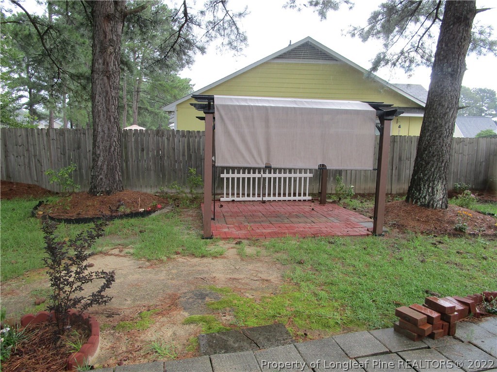 800 Turkey Ridge Drive Fayetteville, NC 28314 - Photo 4 of 23 a view of a backyard with a small cabin and wooden fence