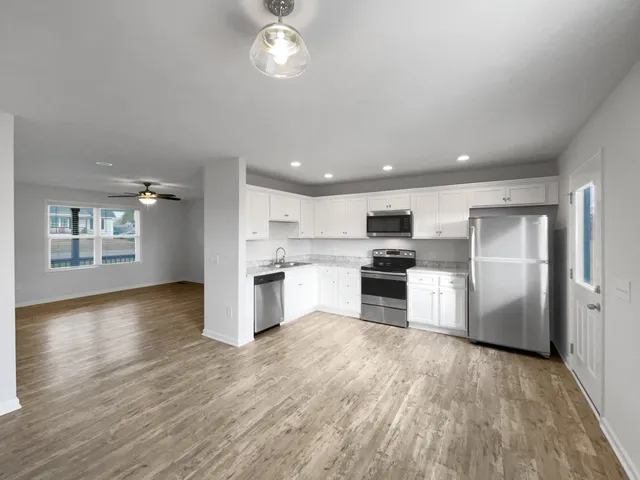 a kitchen with a refrigerator and a oven