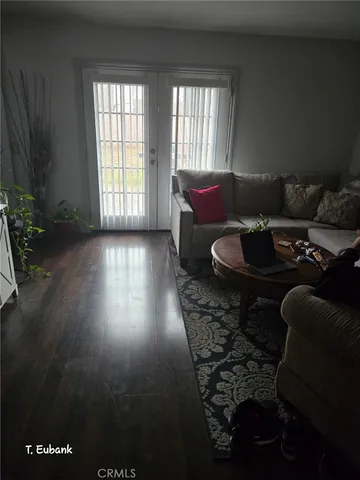 a living room with furniture and a floor to ceiling window