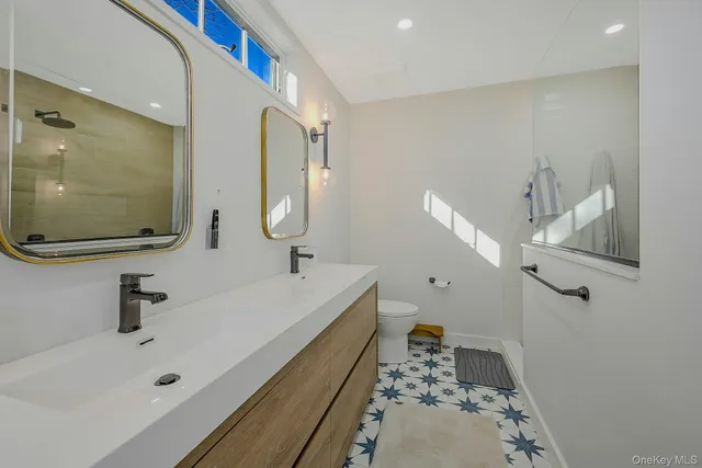 a bathroom with a tub sink and mirror
