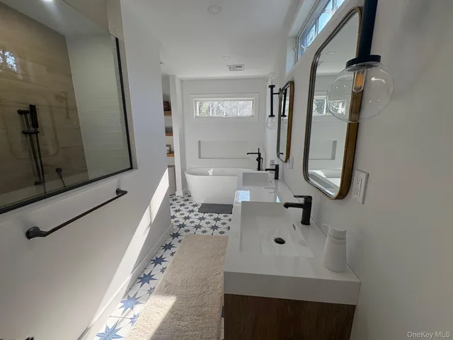 a bathroom with a sink a toilet and mirror