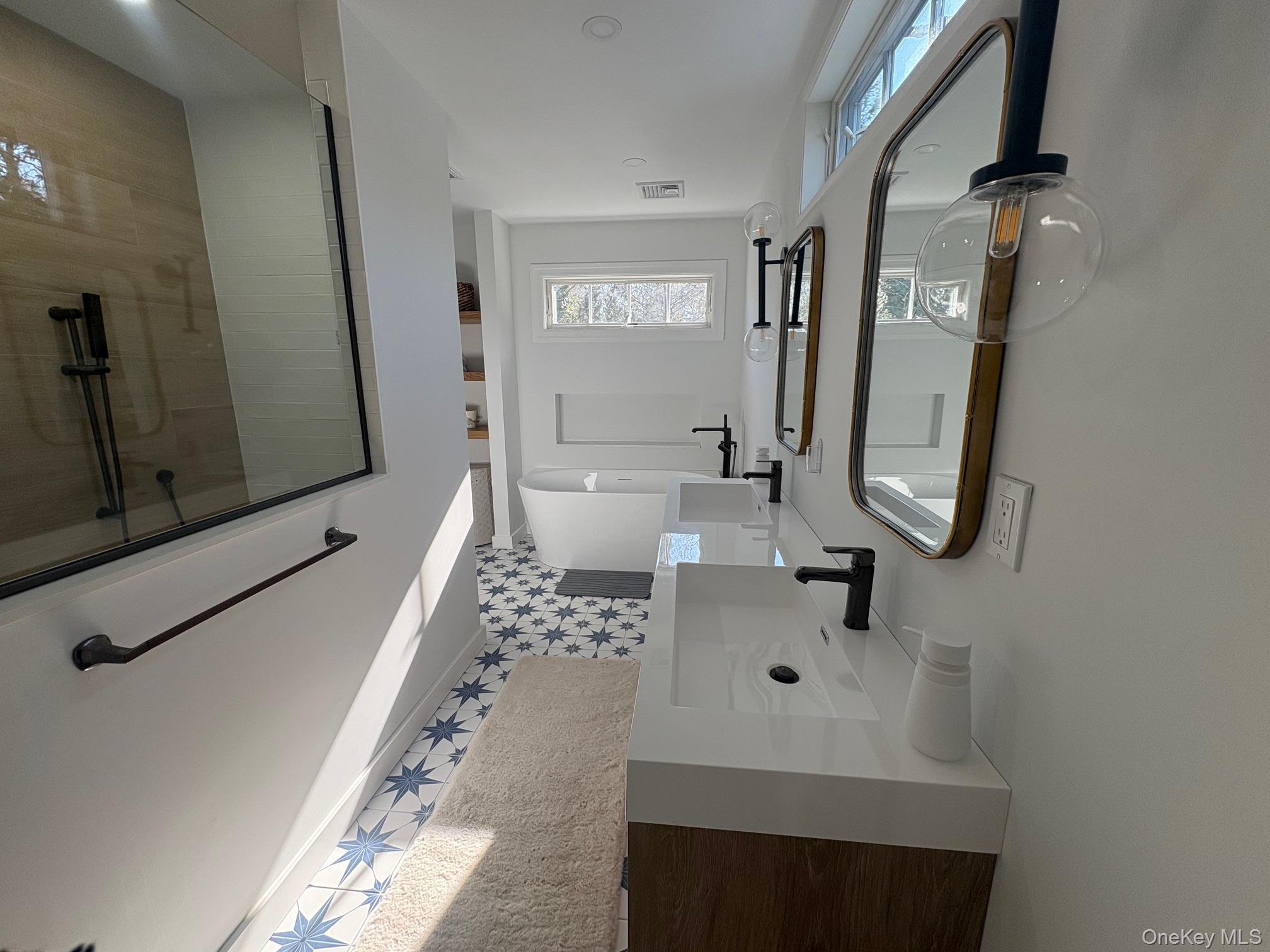 5270 Nassau Point Road Cutchogue, NY 11935 - Photo 13 of 25 a bathroom with a sink a toilet and mirror