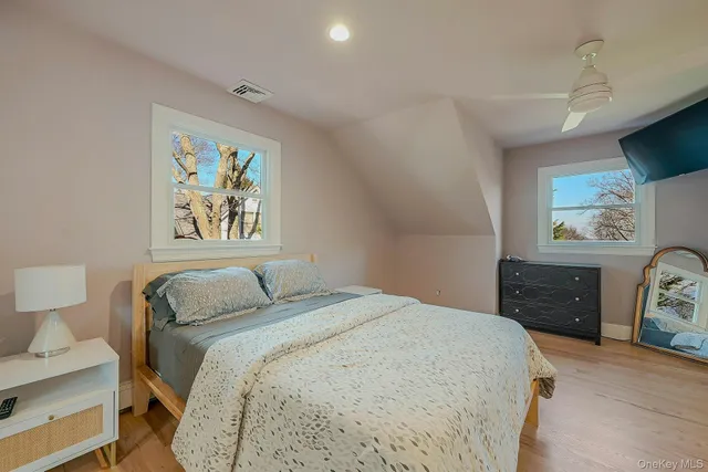 a bedroom with a bed and a painting on the wall