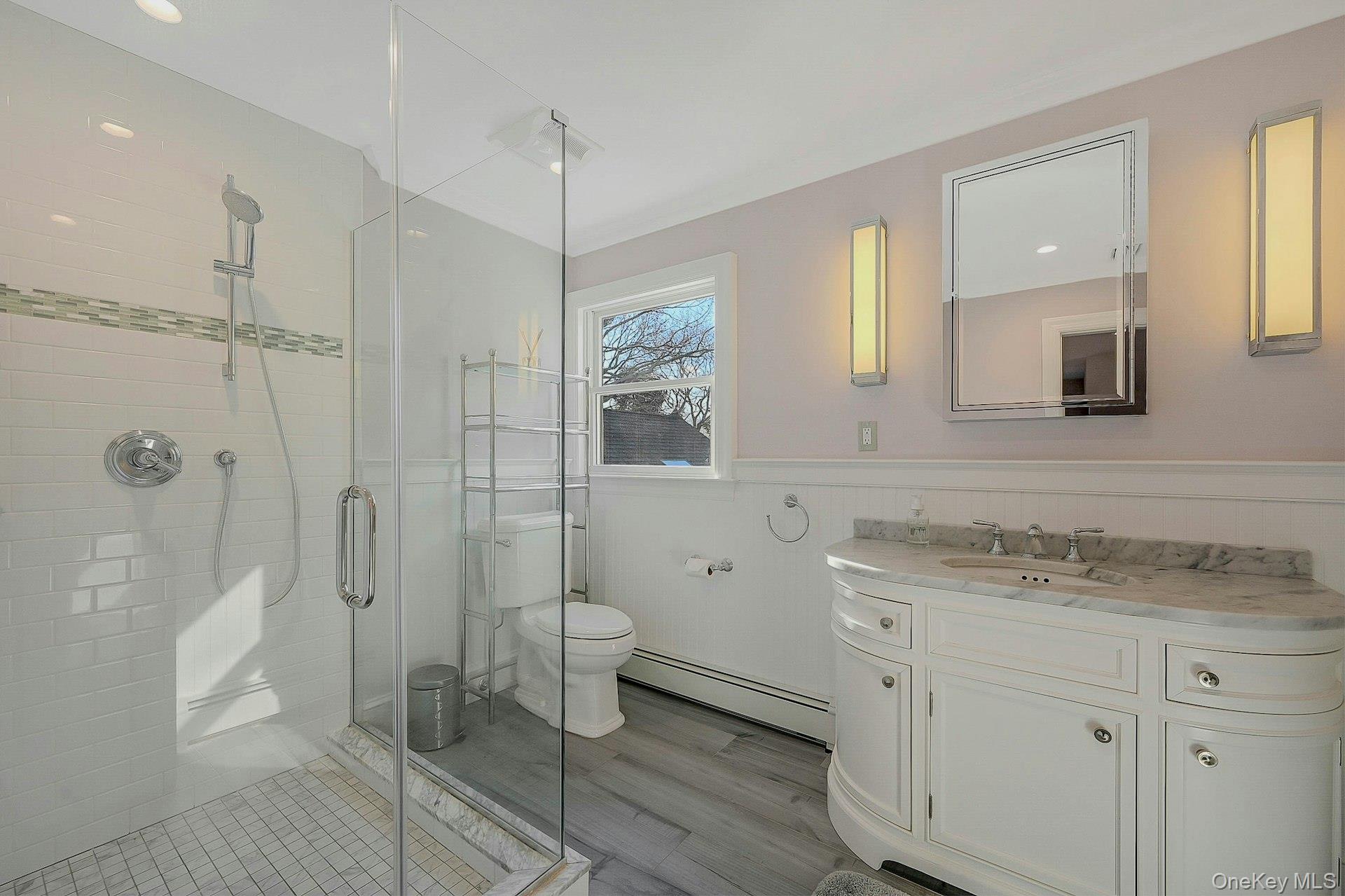 5270 Nassau Point Road Cutchogue, NY 11935 - Photo 16 of 25 a bathroom with a granite countertop sink toilet a shower a mirror and a bathtub