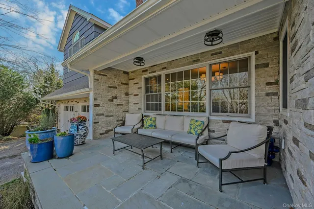 a view of a patio with couple of chairs and a couch
