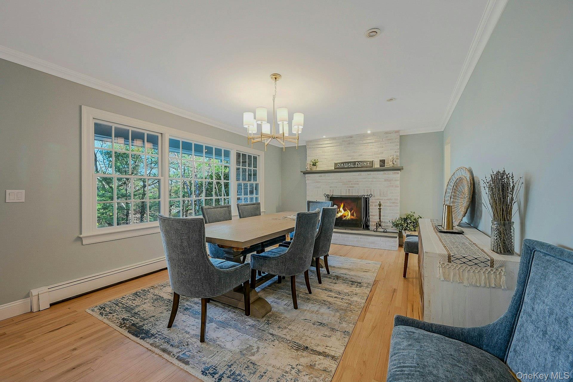 5270 Nassau Point Road Cutchogue, NY 11935 - Photo 8 of 25 a dining room with furniture a chandelier and wooden floor
