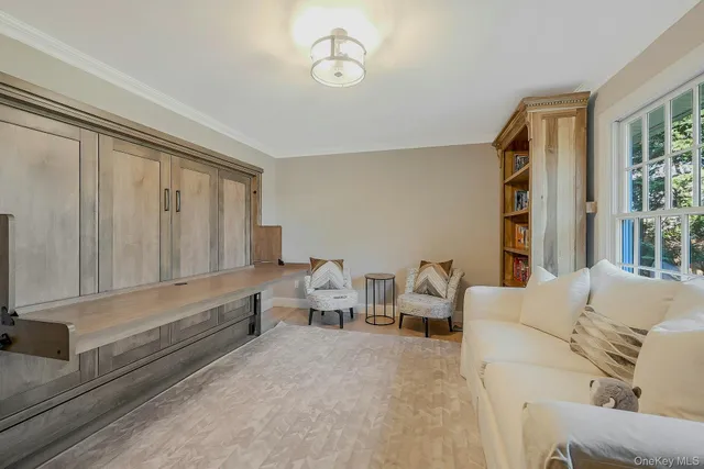 a living room with furniture and large window