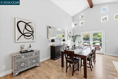 a living room with furniture a fireplace and a large window