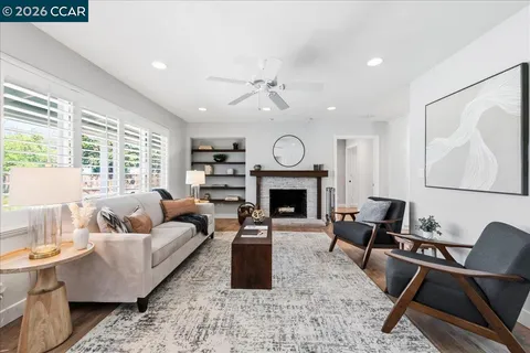 a living room with furniture and a book shelf