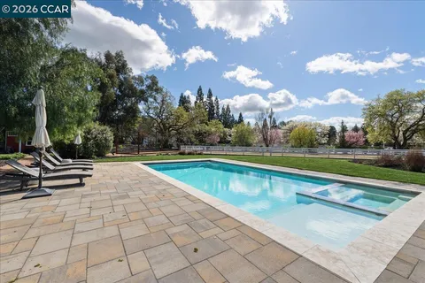 a view of a swimming pool with a lounge chairs