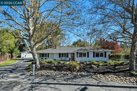 a large kitchen with a table and chairs