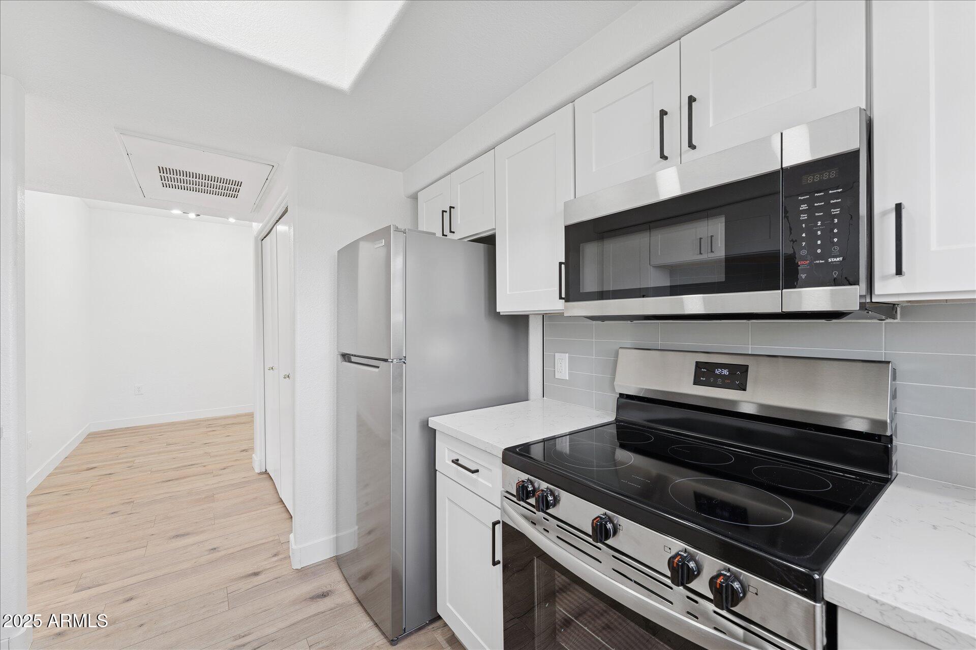 3434 East Baseline Road, Unit 265 Phoenix, AZ 85042 - Photo 11 of 19 a kitchen with cabinets and steel stainless steel appliances