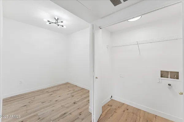 a view of a room with wooden floor and closet