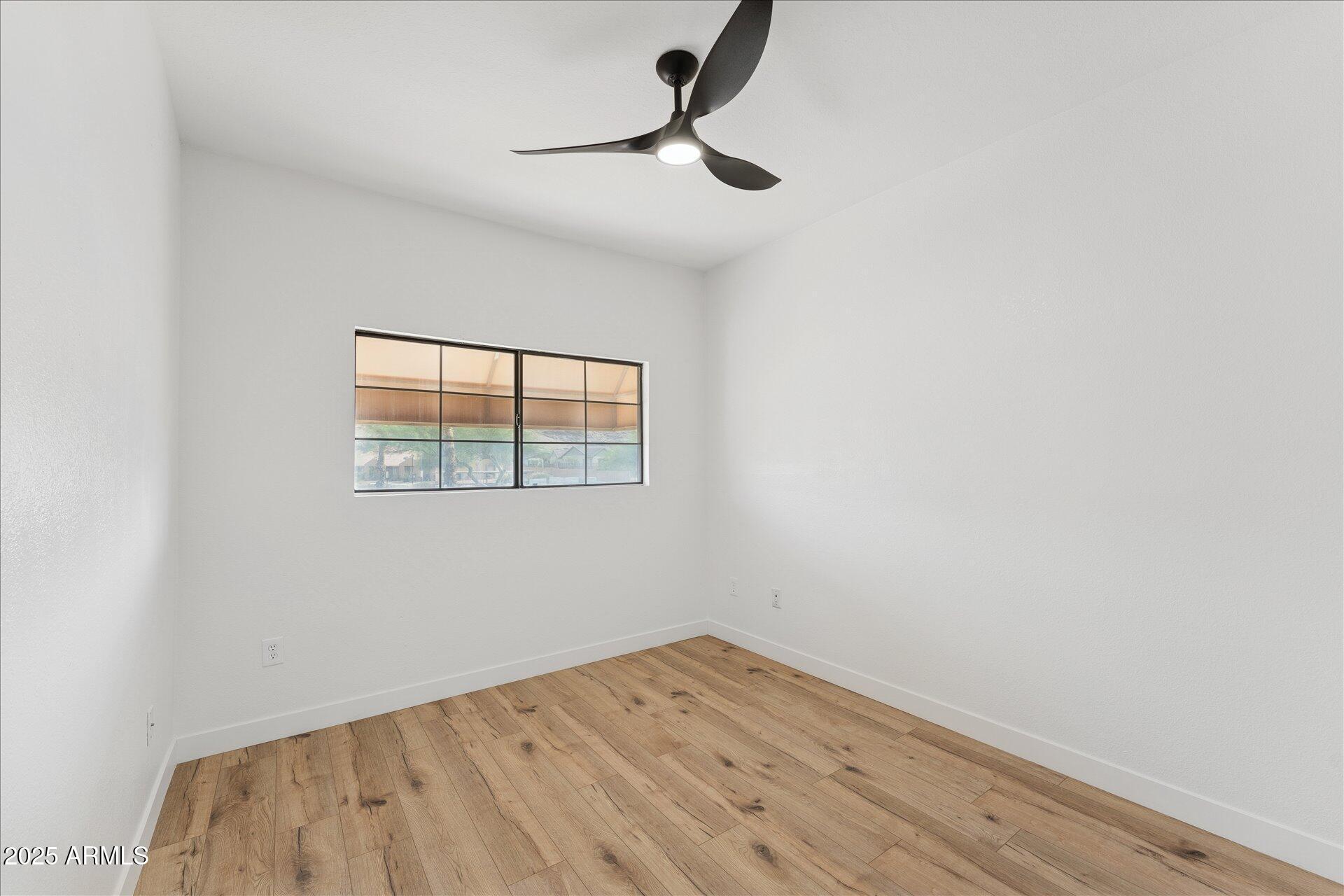 3434 East Baseline Road, Unit 265 Phoenix, AZ 85042 - Photo 16 of 19 a view of empty room with wooden floor