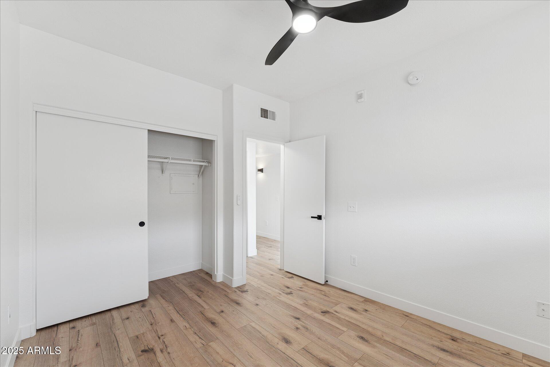 3434 East Baseline Road, Unit 265 Phoenix, AZ 85042 - Photo 17 of 19 a view of an empty room with wooden floor