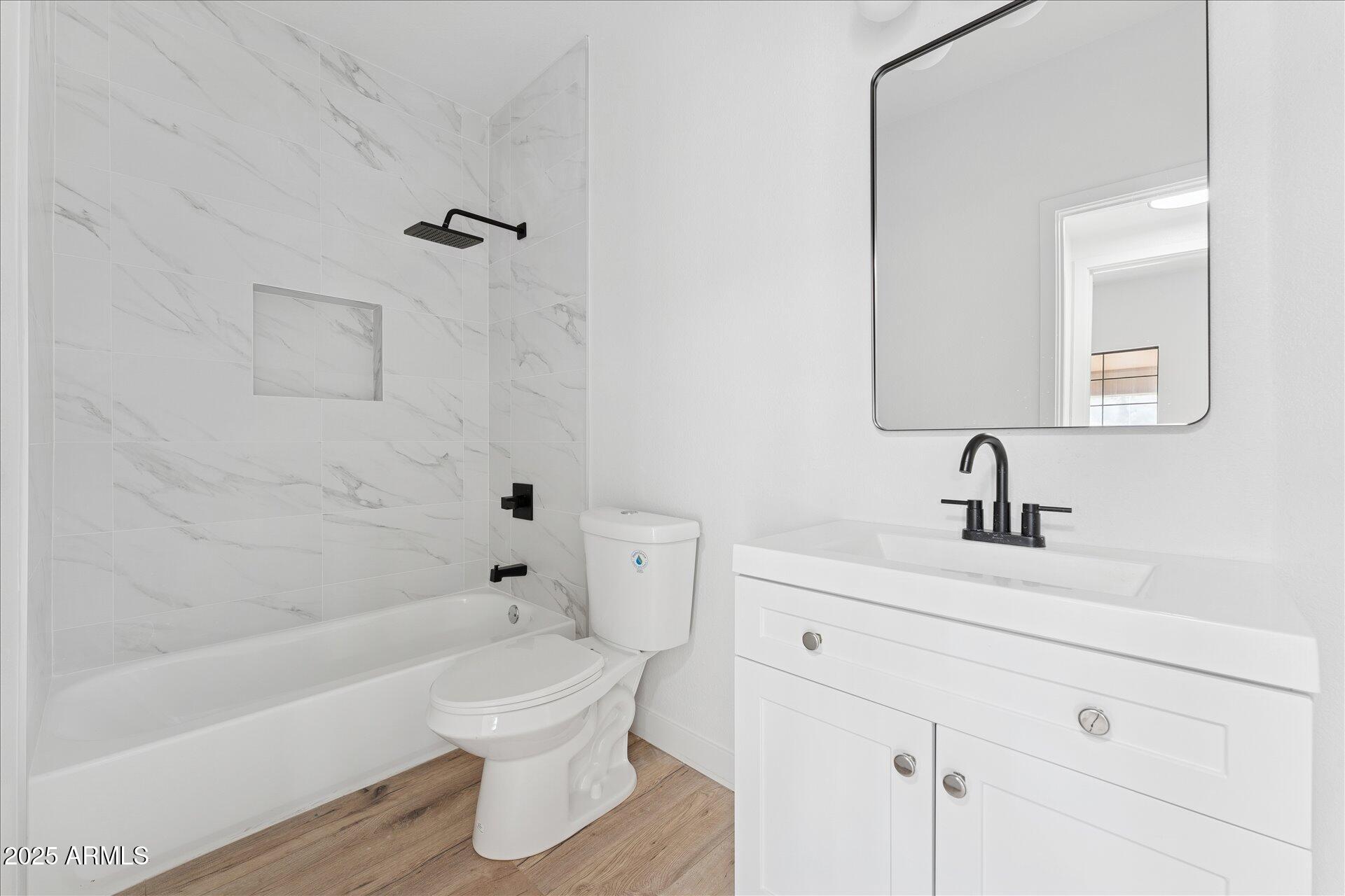 3434 East Baseline Road, Unit 265 Phoenix, AZ 85042 - Photo 18 of 19 a bathroom with a bathtub shower sink mirror and toilet
