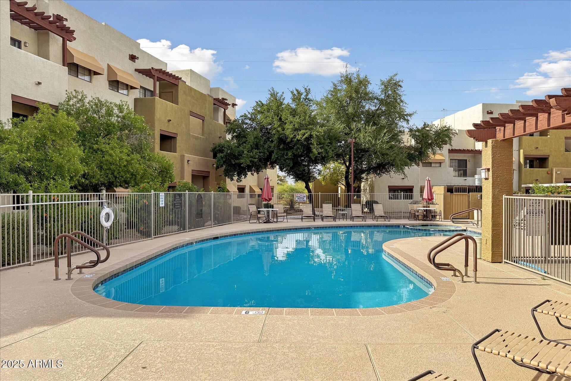 3434 East Baseline Road, Unit 265 Phoenix, AZ 85042 - Photo 19 of 19 a view of a swimming pool with a patio