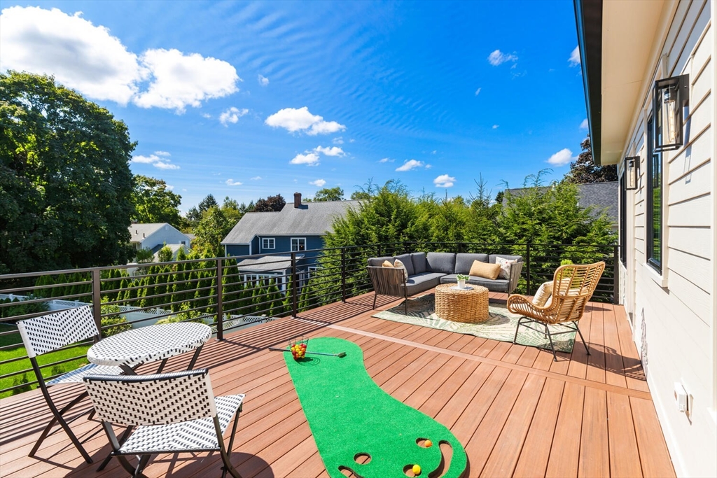 15 West Chardon Road Winchester, MA 01890 - Photo 37 of 42 a view of a patio with a table chairs and a fire pit