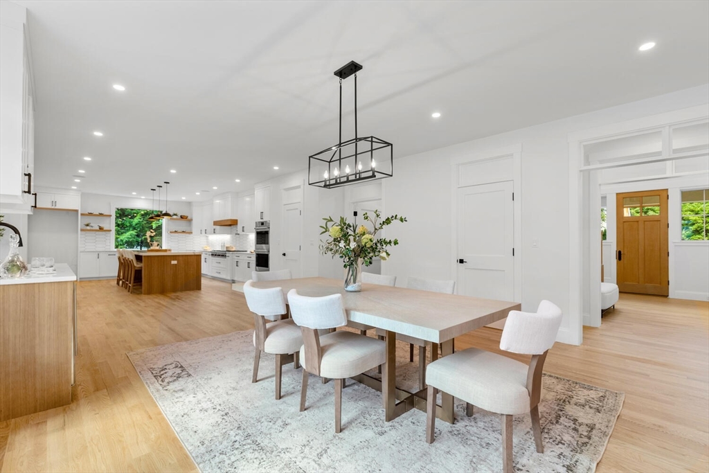 15 West Chardon Road Winchester, MA 01890 - Photo 10 of 42 a view of a dining room and a livingroom with furniture wooden floor a chandelier
