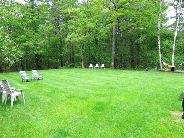 167 Bare Hill Road Boxford, MA 01921 - Photo 20 of 28 a backyard of a house with childrens swings and slides