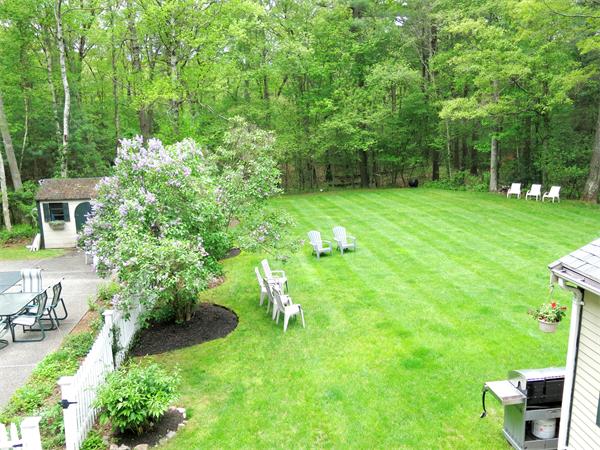 167 Bare Hill Road Boxford, MA 01921 - Photo 23 of 28 a backyard of a house with a garden and outdoor seating