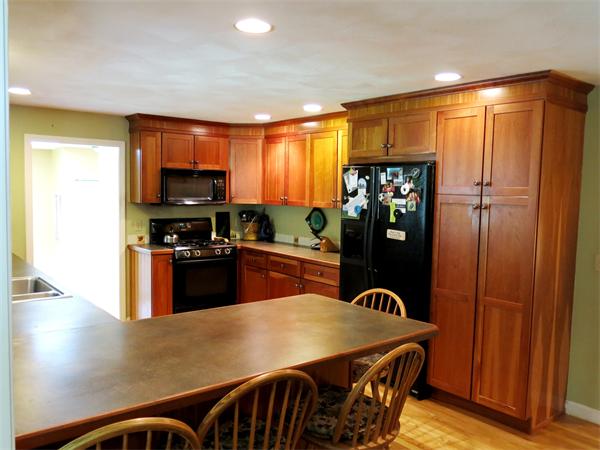 167 Bare Hill Road Boxford, MA 01921 - Photo 9 of 28 a kitchen with stainless steel appliances granite countertop a refrigerator a stove a sink dishwasher with a dining table and chairs