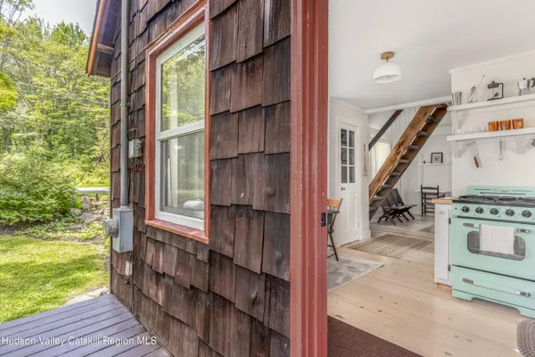 a view of an entryway with wooden floor and staircase