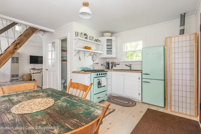 a kitchen with a sink stove and refrigerator