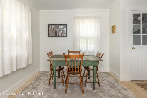 a view of a dining room with furniture and window