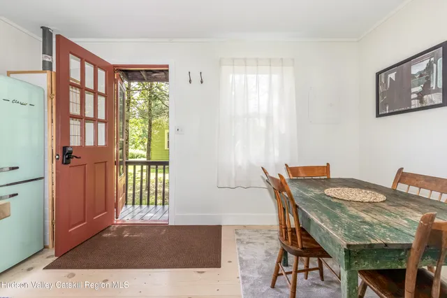 a view of a dining room with furniture and a window