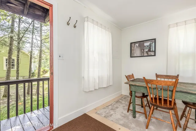 a view of a room with a table and chairs