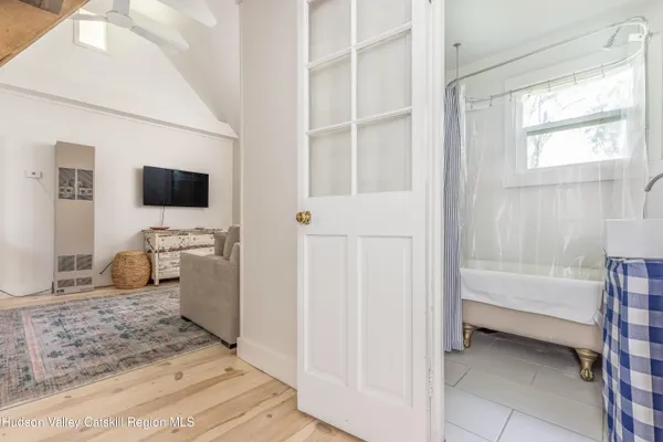 a en suite spacious bathroom with a granite countertop double vanity sink a mirror and a bathtub
