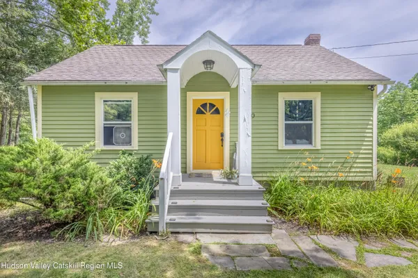 a front view of a house with a garden