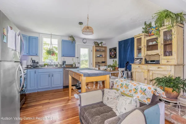 a living room with stainless steel appliances kitchen island granite countertop furniture and a kitchen view