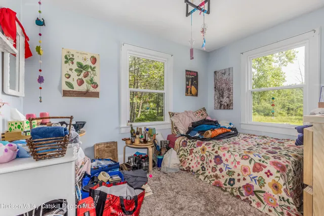 a bedroom with bed and a window