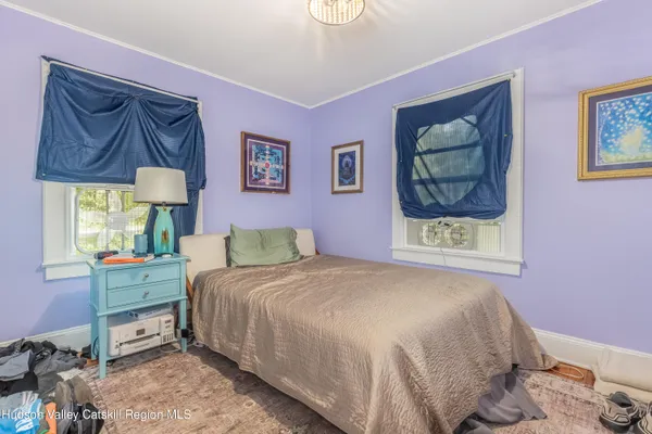 a bedroom with a bed and a painting on the wall