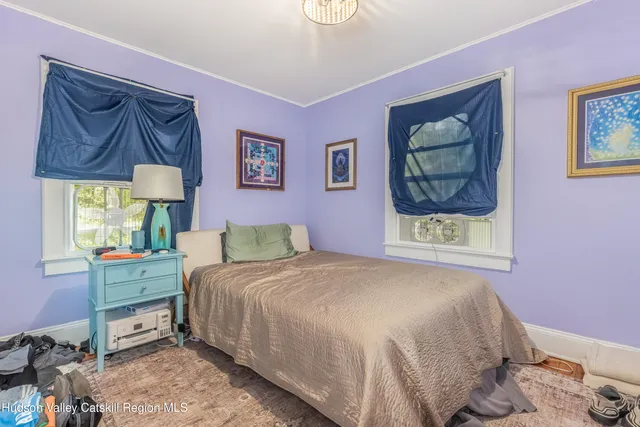 a bedroom with a bed and a painting on the wall