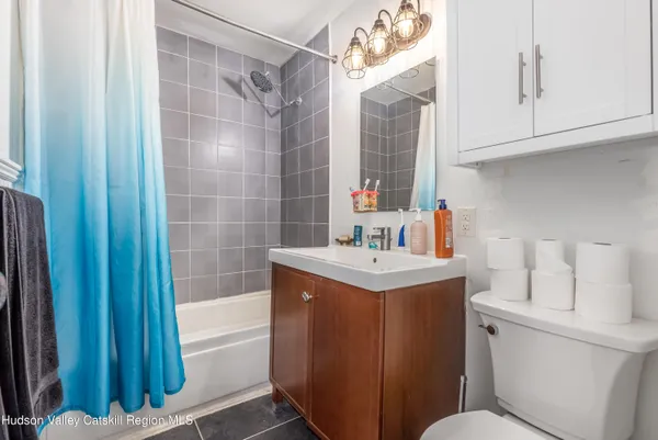 a bathroom with a sink toilet vanity and tub