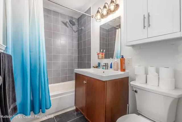 a bathroom with a sink toilet vanity and tub