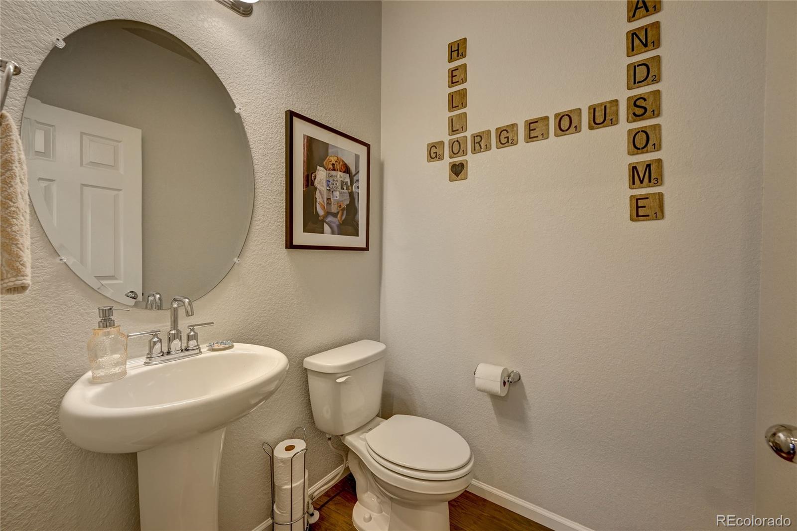 7203 Bedlam Drive Castle Pines, CO 80108 - Photo 15 of 39 a bathroom with a toilet sink and mirror