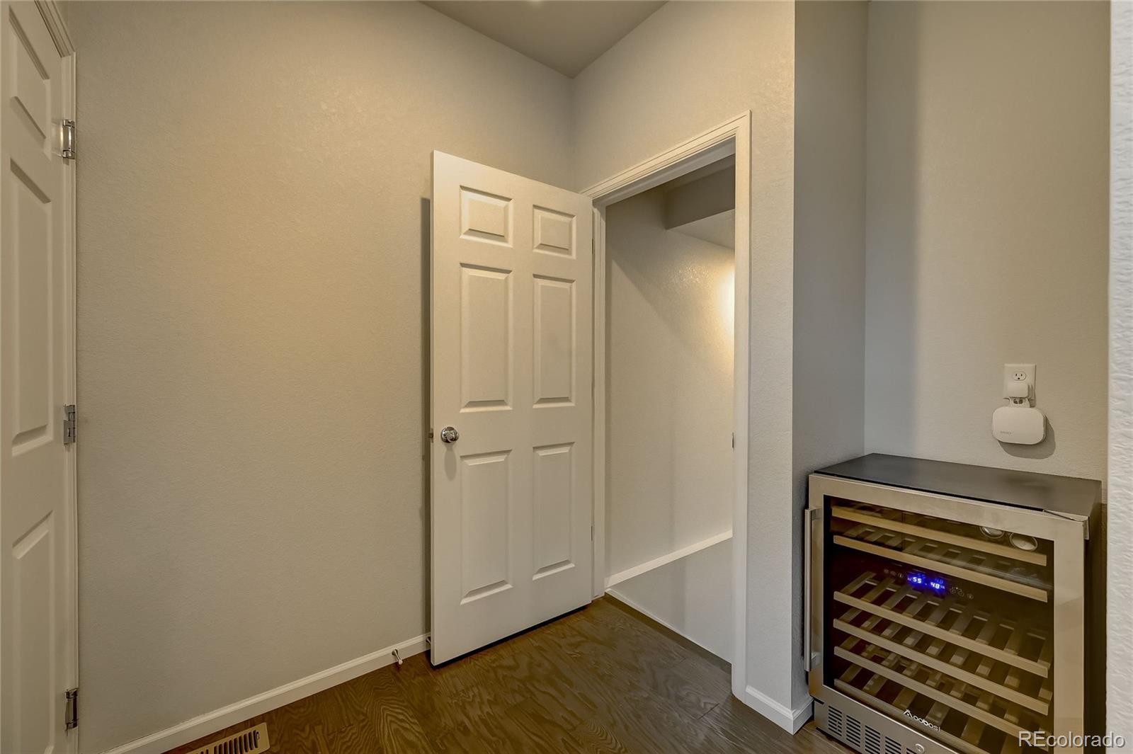 7203 Bedlam Drive Castle Pines, CO 80108 - Photo 16 of 39 a view of a hallway and closet with wooden floor