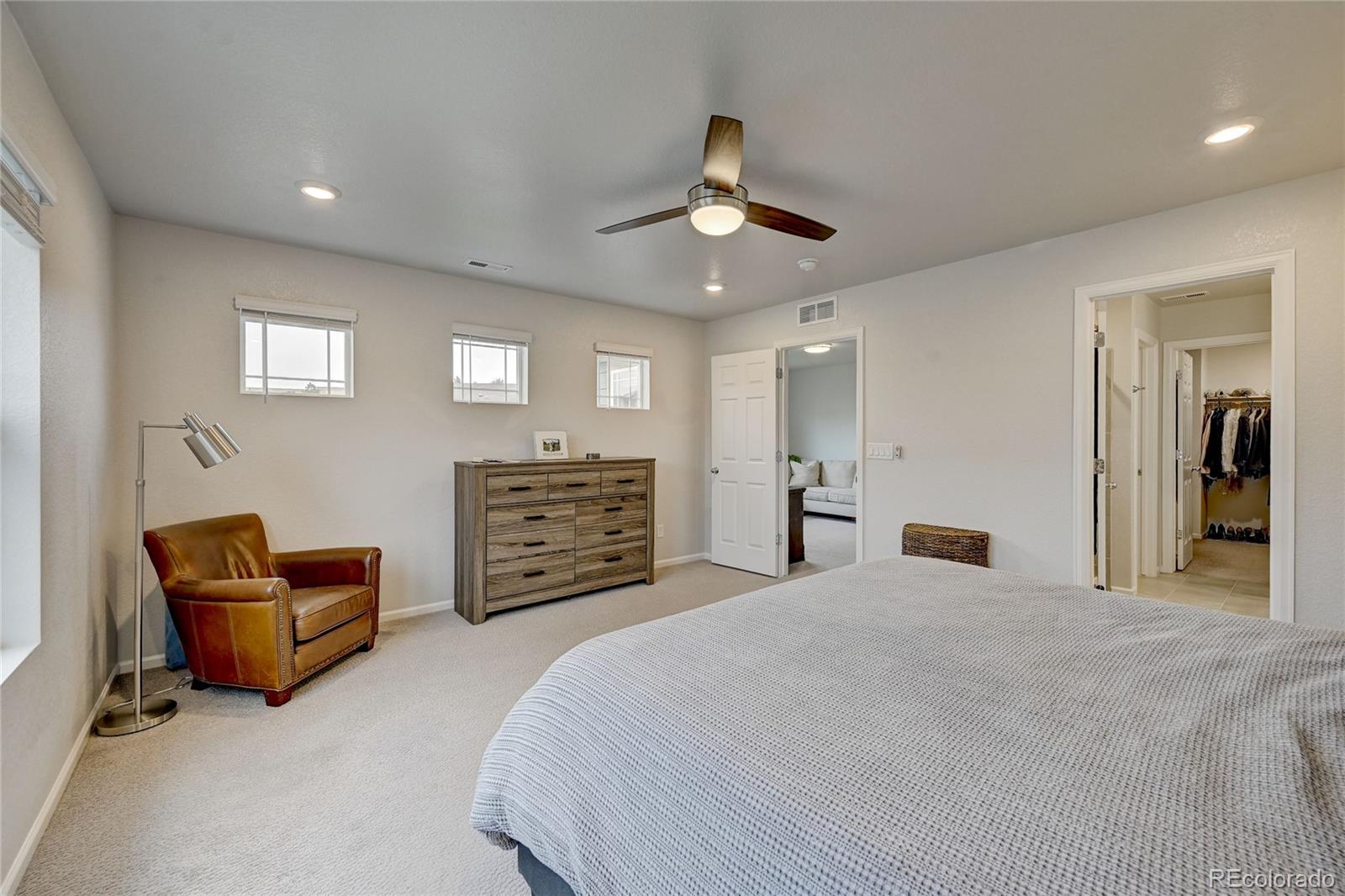 7203 Bedlam Drive Castle Pines, CO 80108 - Photo 18 of 39 a large bedroom with bed and furniture