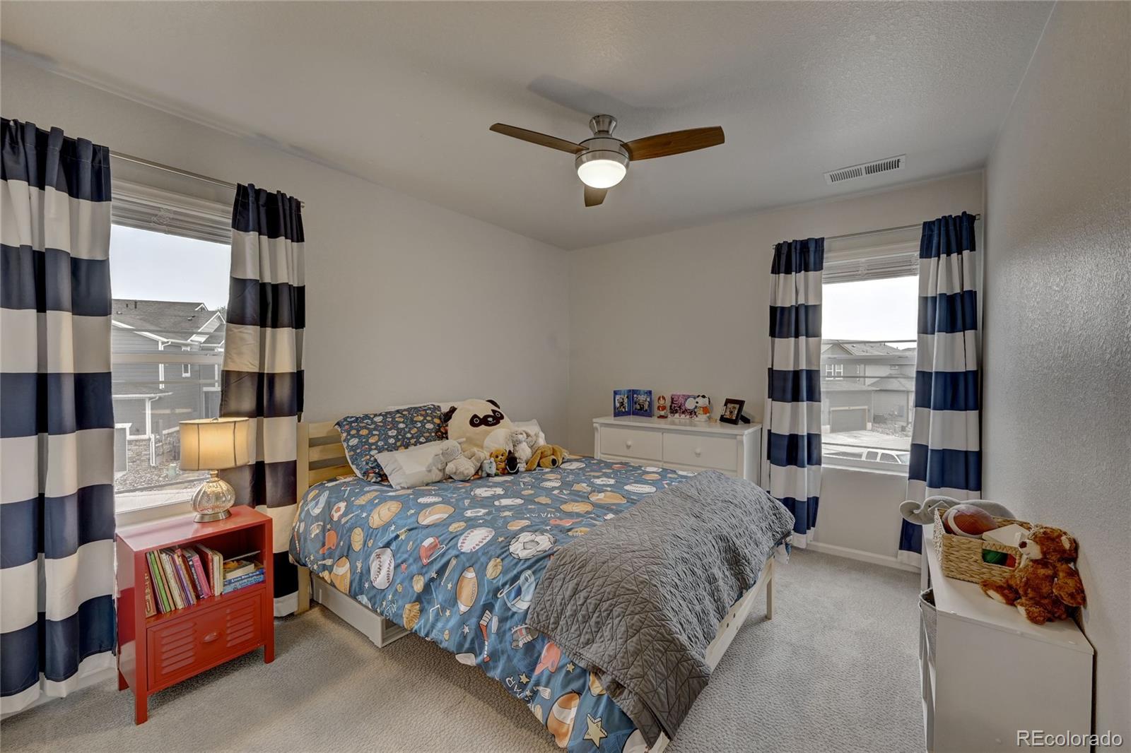 7203 Bedlam Drive Castle Pines, CO 80108 - Photo 26 of 39 a bedroom with double bed and a window